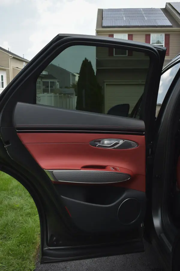 Genesis door open on the clean red interior