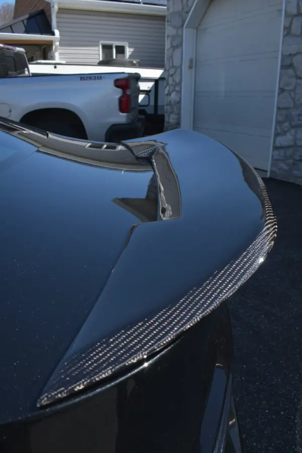 Carbon fiber trunk lip on the Lexus, wiped down by hand
