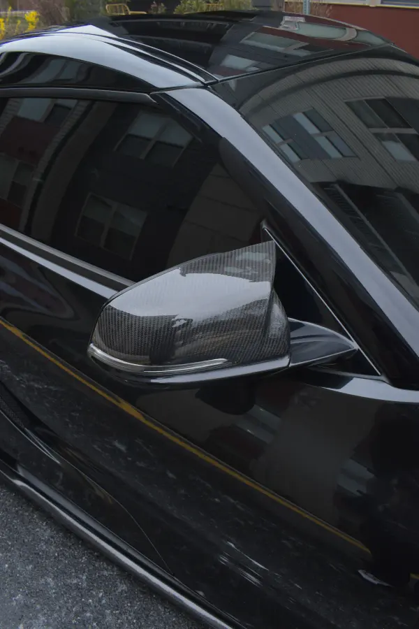 Carbon mirror cap and black paint on the Supra, finished by hand